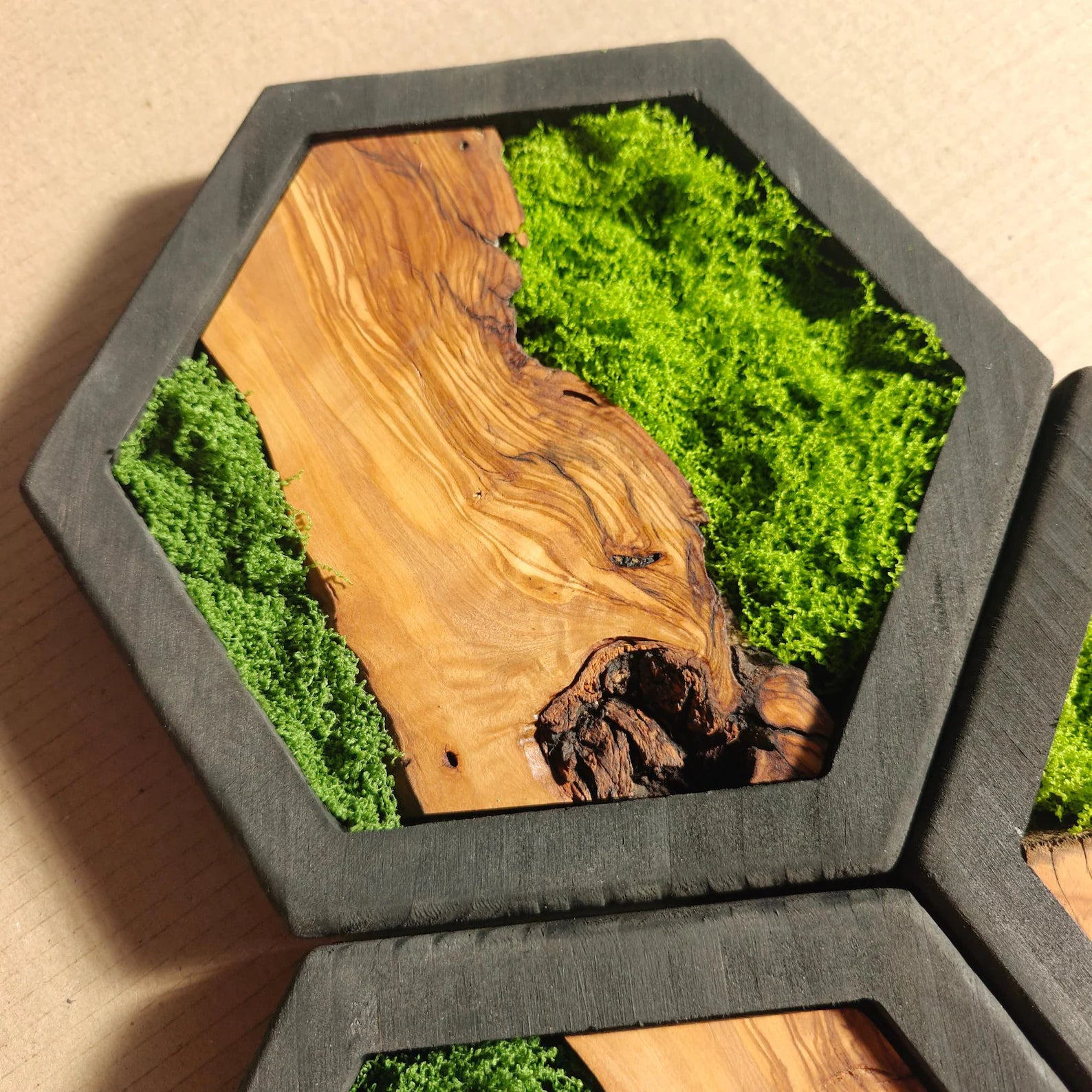Hexagonal wooden tray with natural wood and green moss